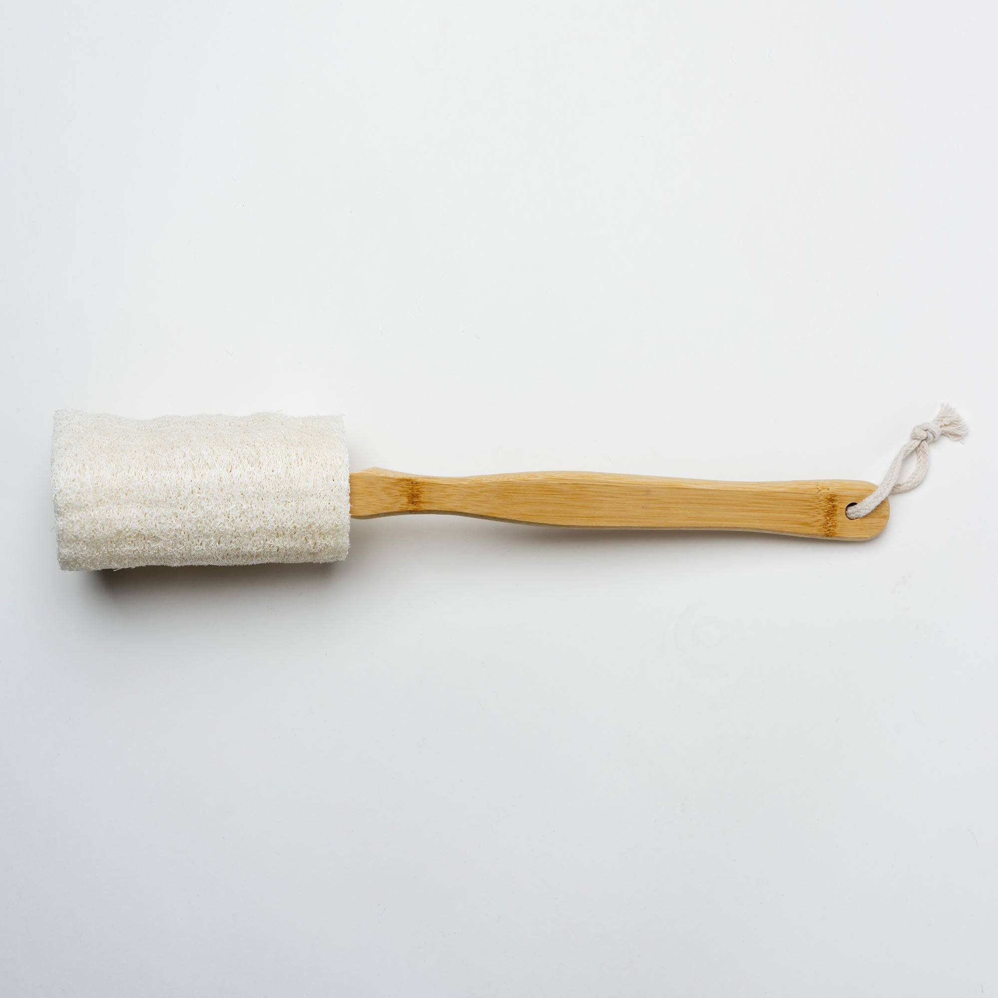 Bamboo body scrubber with a white loofah on a light gray background. Victoria James Body Loofah Brush